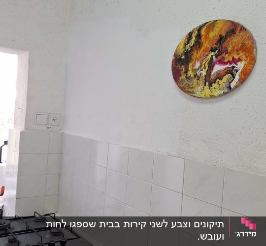 מטבח עם כיריים וקיר אריחים לבנים